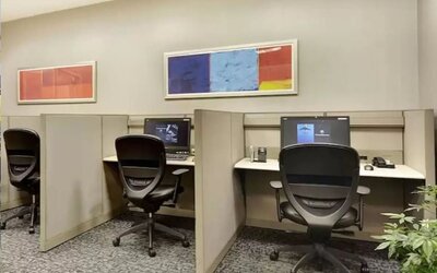 Business center with computers, printer and ergonomic chairs at New York Hilton Midtown.