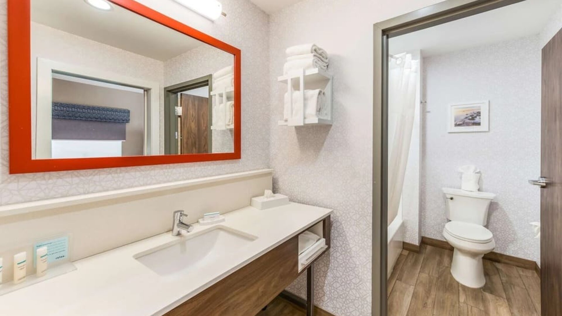 Private guest bathroom with shower and free toiletries at Hampton Inn & Suites Benton Harbor.