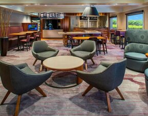 Lobby lounge area and workspace at Sonesta Select Boston Lowell Chelmsford.