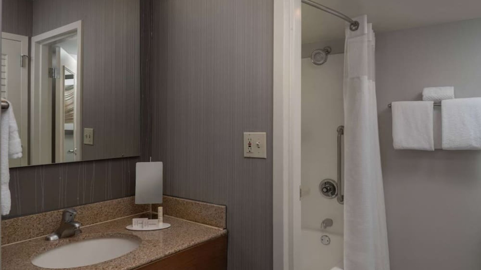 Private guest bathroom with shower and free toiletries at Sonesta Select Chattanooga Hamilton Place.