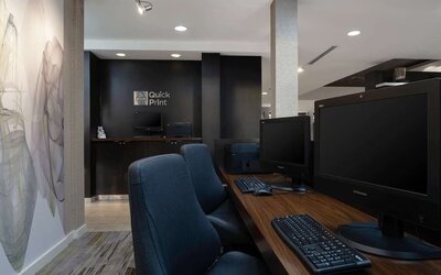 Business center with computers, printer and ergonomic chairs at Sonesta Select Chattanooga Hamilton Place.