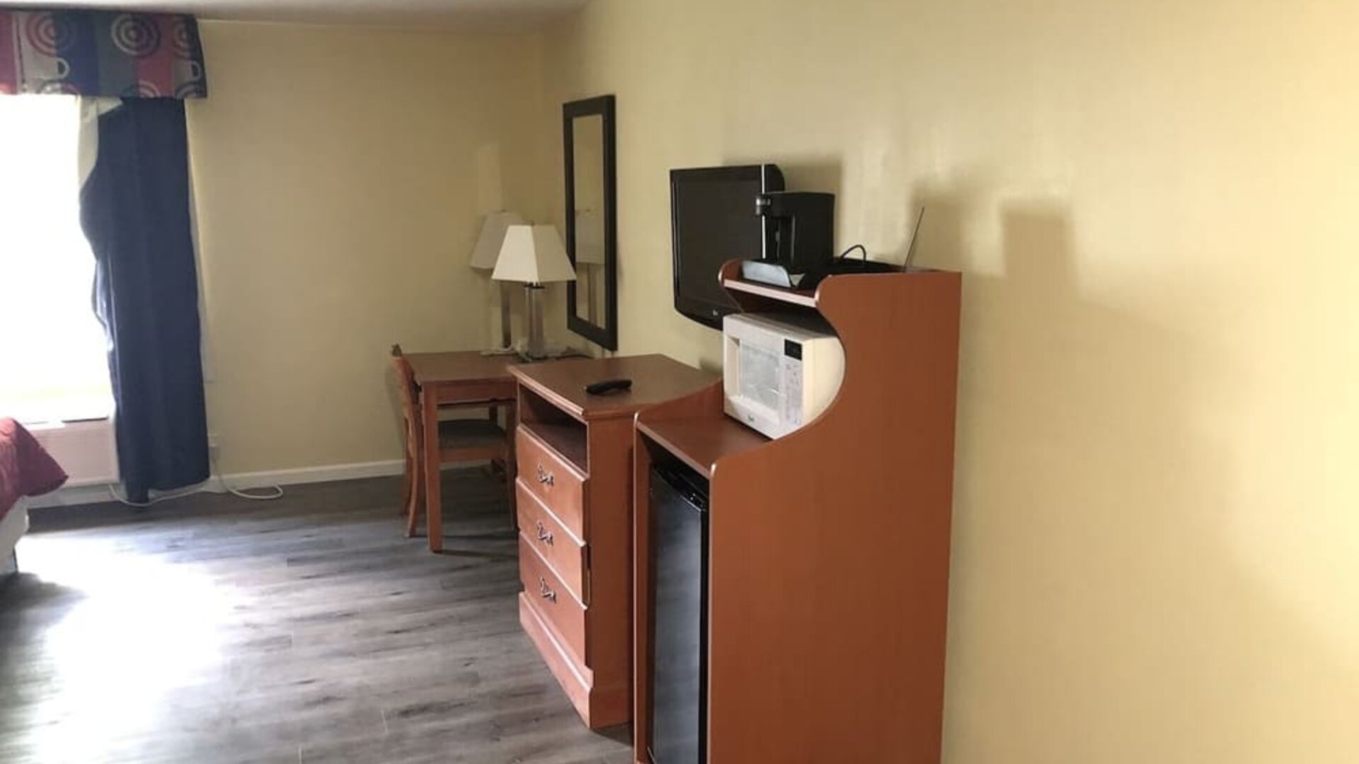 TV and mini-fridge at Quality Inn & Suites Woodstock Near Lake Geneva.