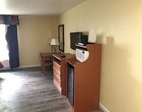 TV and mini-fridge at Quality Inn & Suites Woodstock Near Lake Geneva.