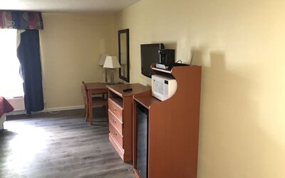 TV and mini-fridge at Quality Inn & Suites Woodstock Near Lake Geneva.