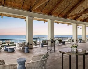 Lounge area at Embassy Suites By Hilton Panama City Beach Resort's terrace.