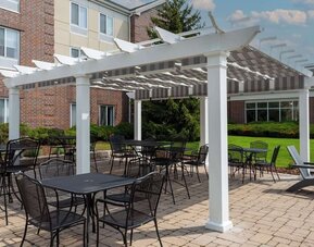 Hotel patio with seating area at Hilton Garden Inn Milwaukee Northwest Conference Center.