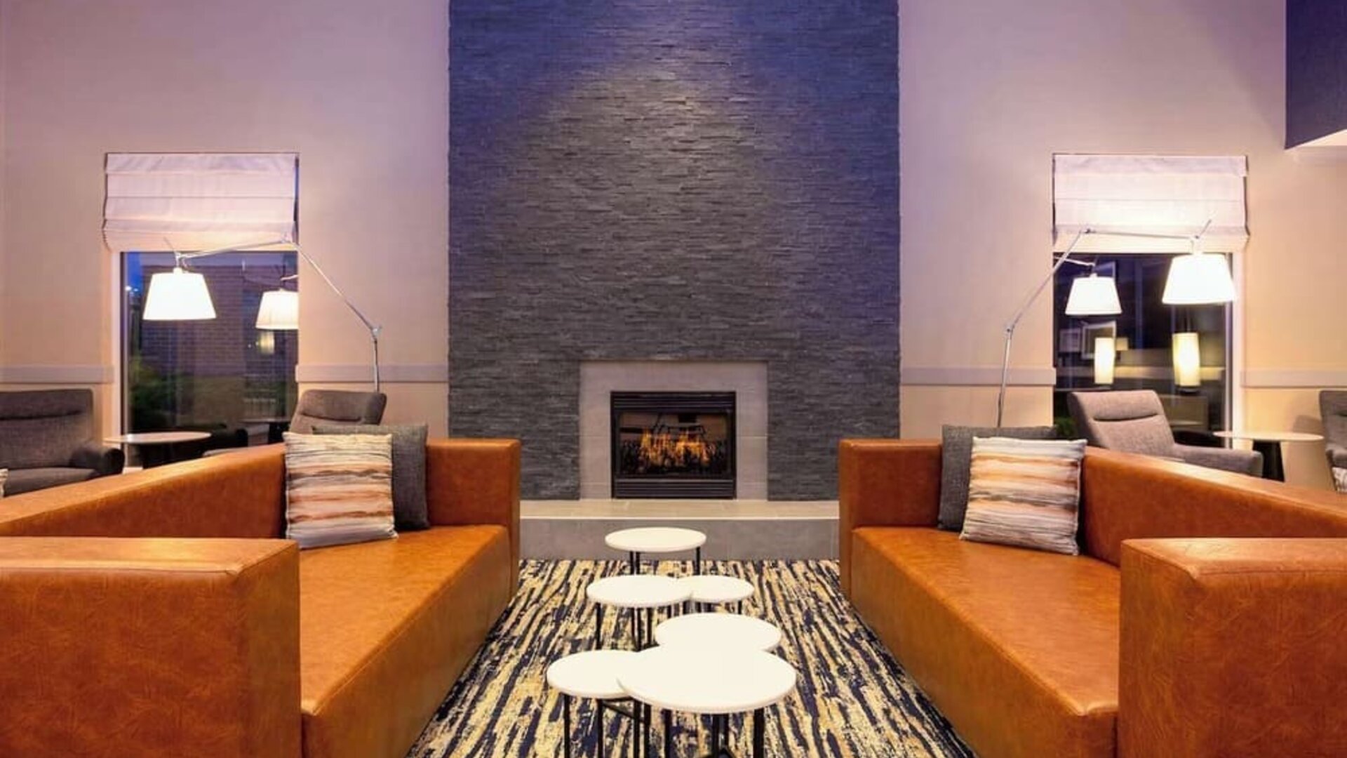 Comfortable lobby lounge with fireplace at Hilton Garden Inn Milwaukee Northwest Conference Center.