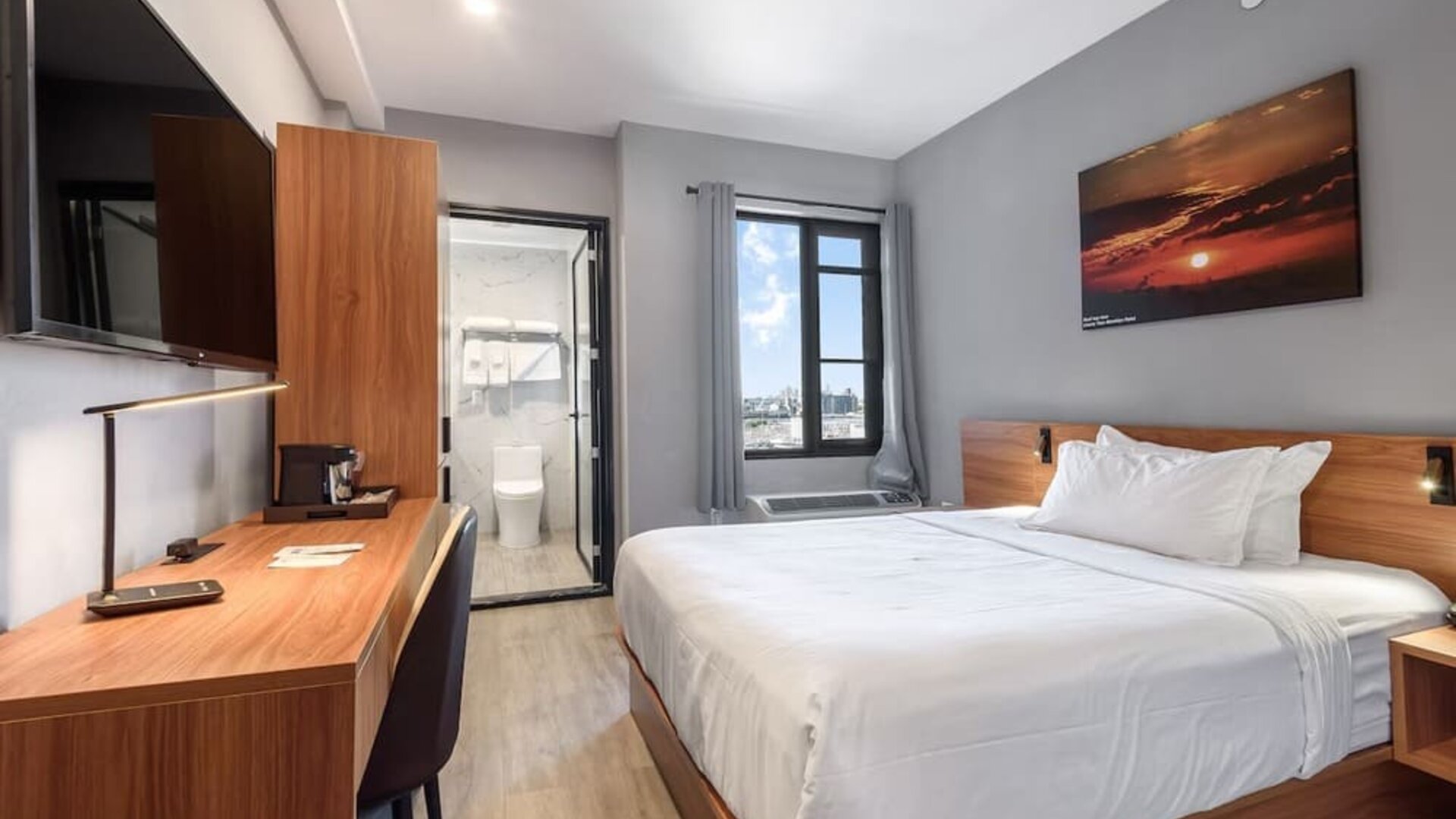 Day use room with work desk and natural light at Liberty View Brooklyn Hotel.