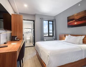 Day use room with work desk and natural light at Liberty View Brooklyn Hotel.