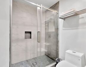 Private guest bathroom with shower at Exclusivo Inn & Suites. 