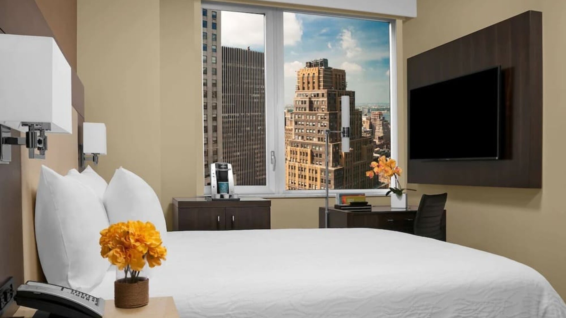 Day use room with work desk, TV screen and private bathroom at Hilton Garden Inn New York/Times Square Central.