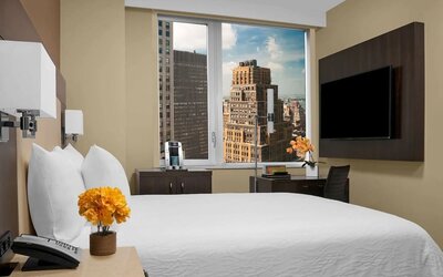 Day use room with work desk, TV screen and private bathroom at Hilton Garden Inn New York/Times Square Central.