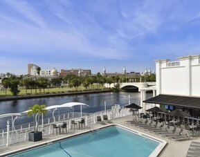 Outdoor pool with lounge area at Hotel Tampa Riverwalk.