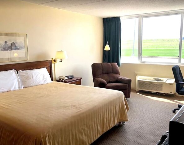 Bright and spacious day use room with work desk and sofa at Norwood Inn And Suites Worthington.