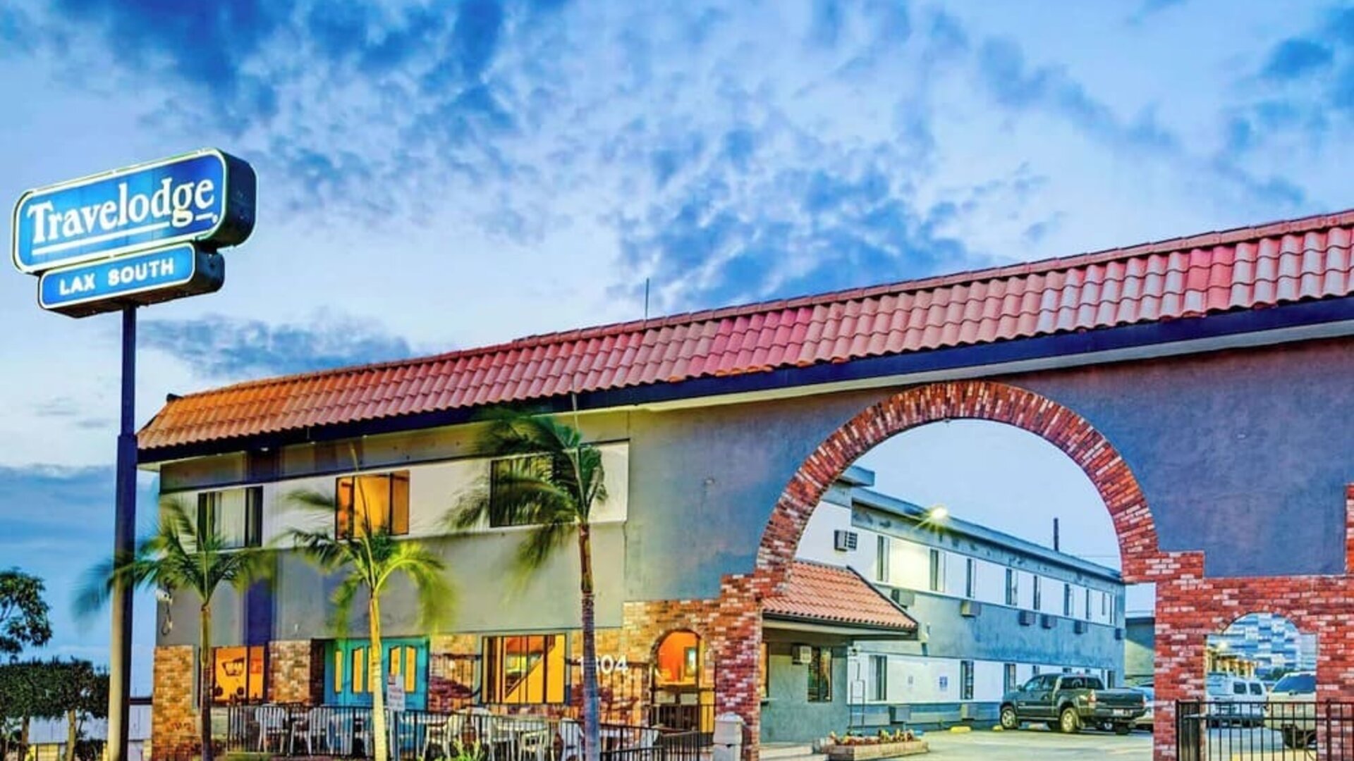 Hotel exterior and parking area at Travelodge LAX By Wyndham.