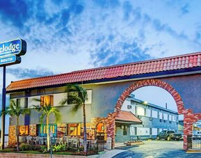 Hotel exterior and parking area at Travelodge LAX By Wyndham.
