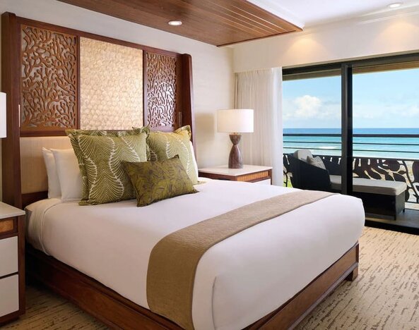 King bed at Ko'a Kea Resort On Po`ipu Beach.