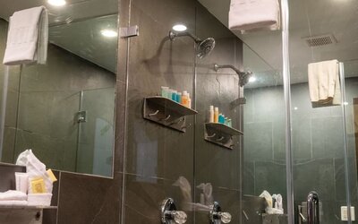 Private guest bathroom with shower and free toiletries at Hotel Chelsea, A South Beach Group Hotel.