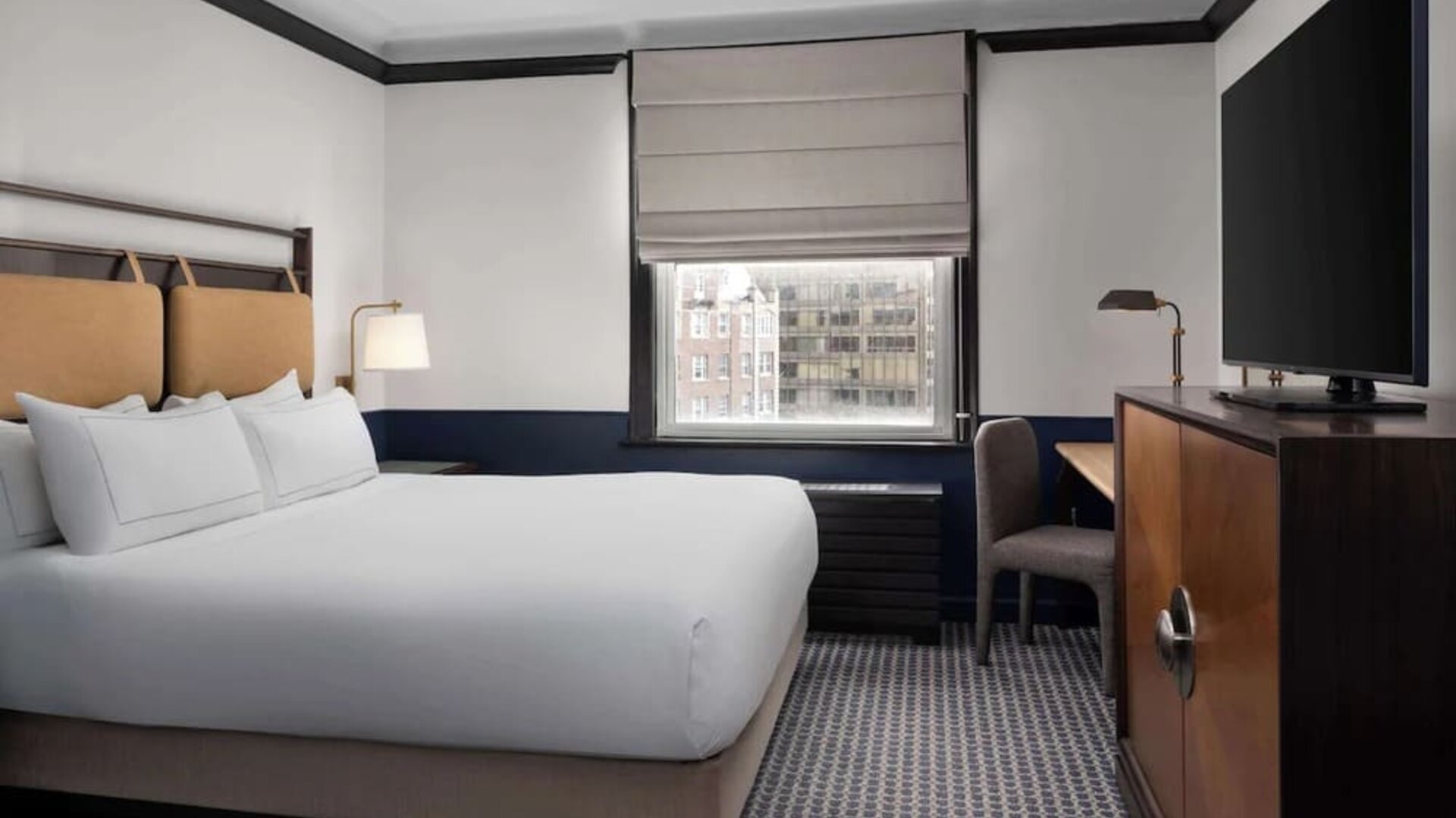 Standard room with work desk and TV screen at Hilton Orrington/Evanston.