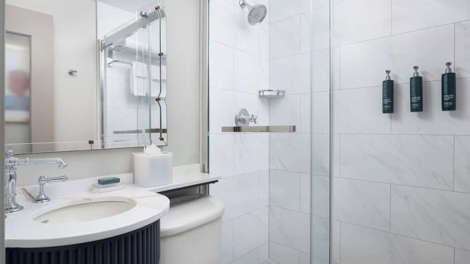 Private guest bathroom with shower and free toiletries at Hilton Orrington/Evanston.