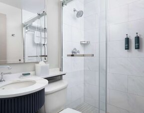 Private guest bathroom with shower and free toiletries at Hilton Orrington/Evanston.