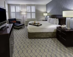 Bright and spacious day use room with work desk and sofa at Hilton Orrington/Evanston.