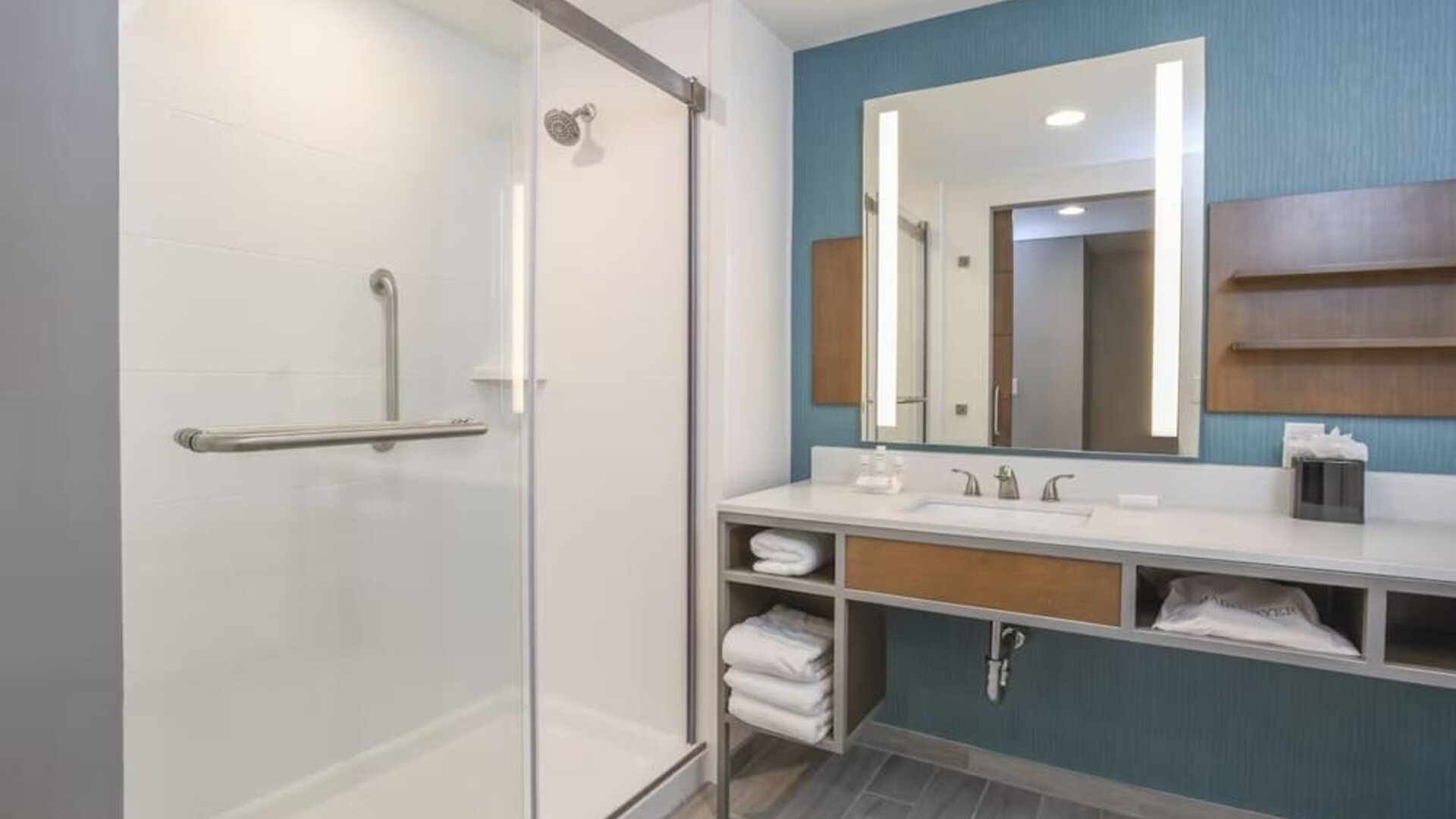 Private guest bathroom with shower and free toiletries at Hilton Garden Inn Cincinnati Midtown.