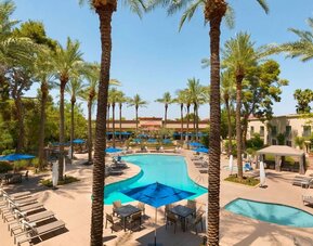 Outdoor pool with lounge chairs at Hilton Scottsdale Resort & Villas.