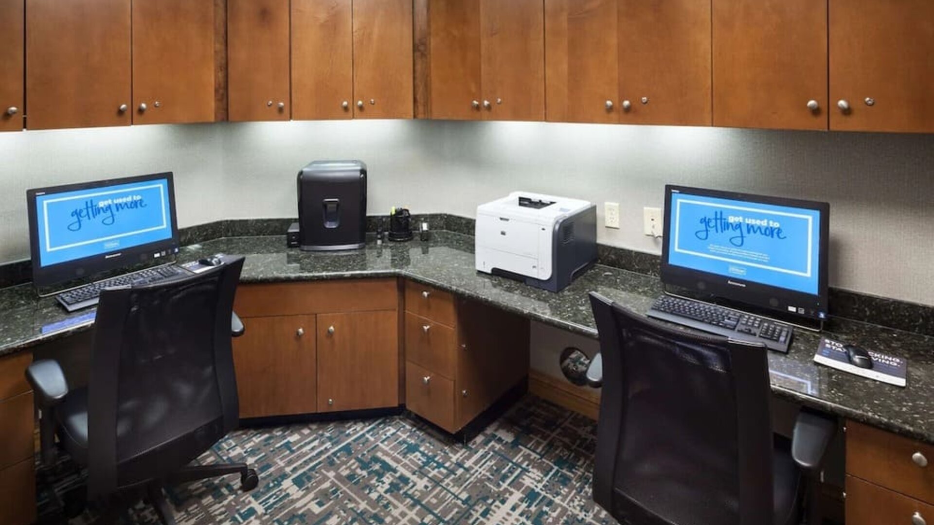 Business center with computers, printer and ergonomic chairs at Hampton Inn Los Angeles-Orange County-Cypress.