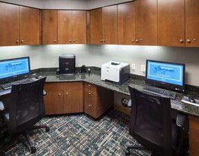 Business center with computers, printer and ergonomic chairs at Hampton Inn Los Angeles-Orange County-Cypress.