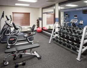 Fully equipped fitness center at Hampton Inn Los Angeles-Orange County-Cypress.