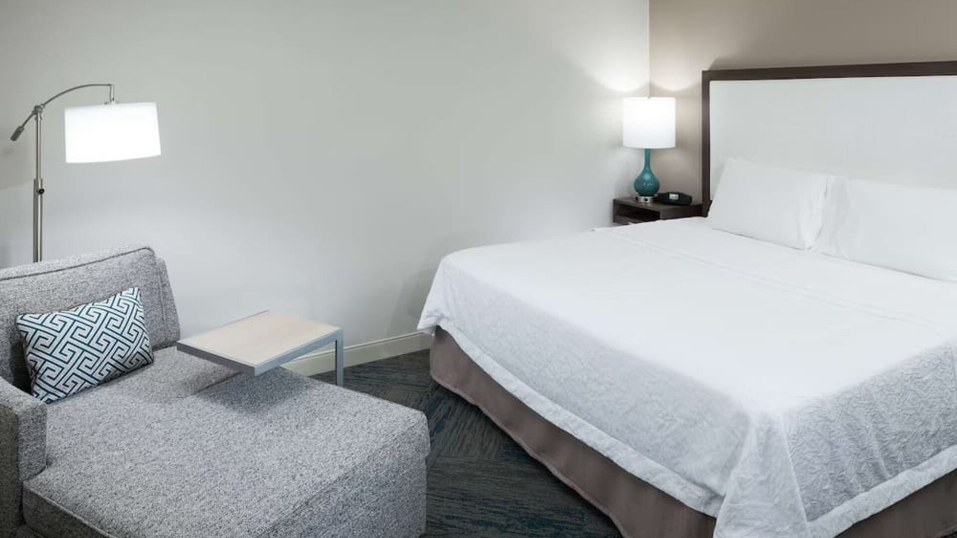 King bed and sofa at Hampton Inn Los Angeles-Orange County-Cypress.
