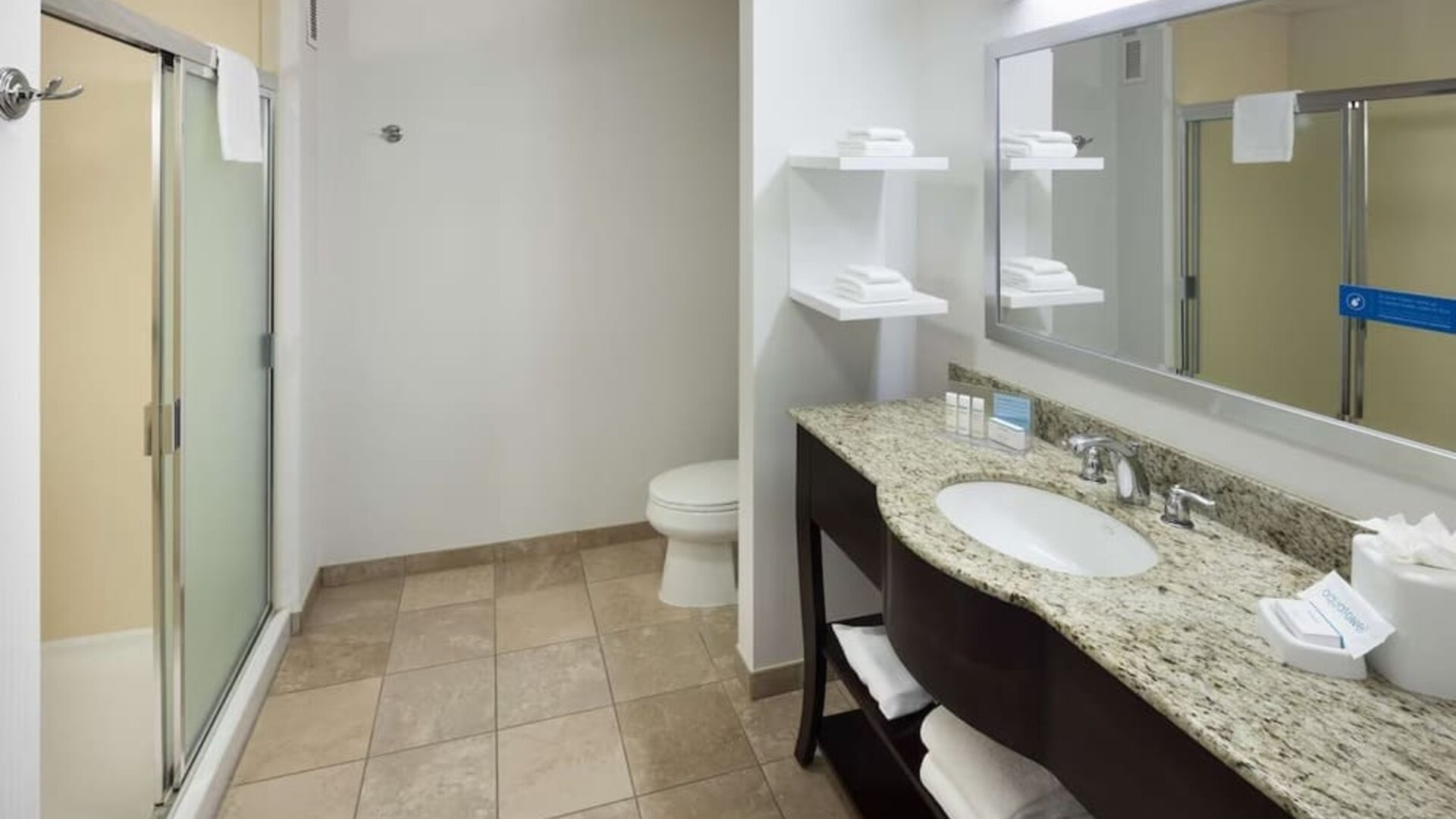 Private guest bathroom with shower and free toiletries at Hampton Inn Los Angeles-Orange County-Cypress.