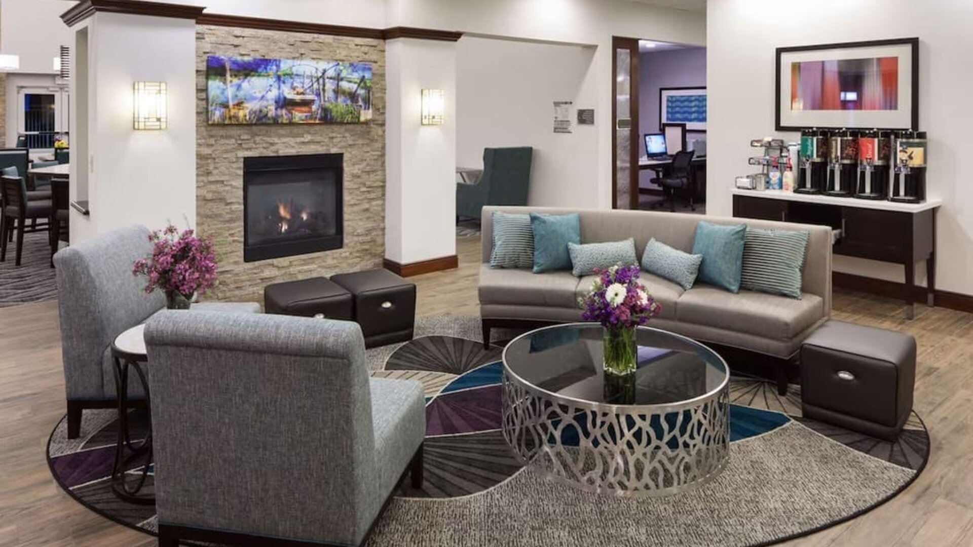 Lobby lounge with fireplace and workspace at Homewood Suites By Hilton Agoura Hills.