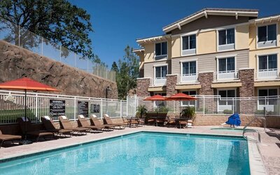 Outdoor pool with lounge chairs at Homewood Suites By Hilton Agoura Hills.