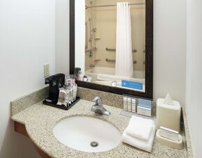 Private guest bathroom with combined shower and tub at Hampton Inn & Suites Clovis-Airport North.