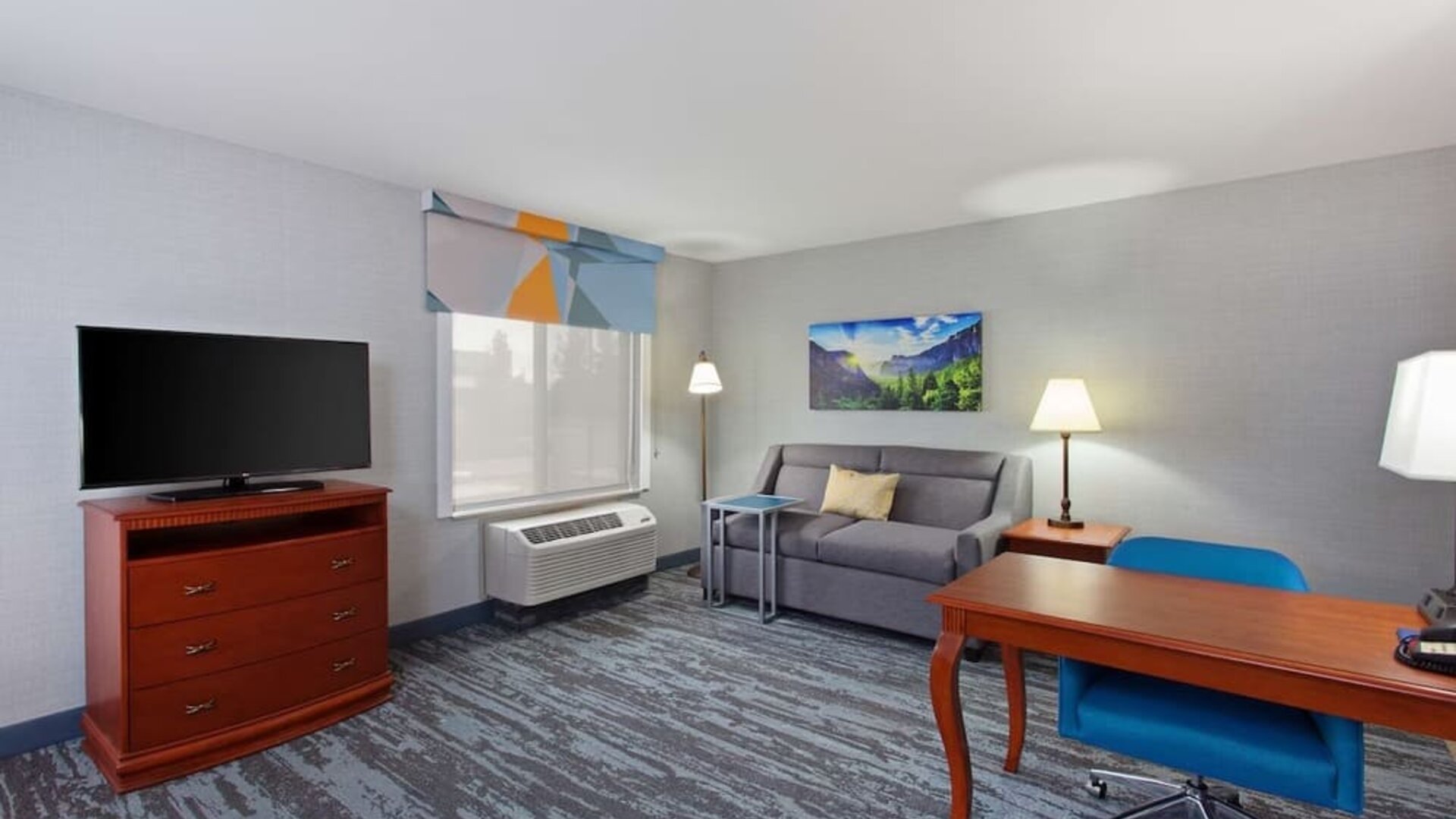 Day use suite with work desk and sofa at Hampton Inn & Suites Clovis-Airport North.