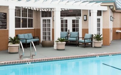 Outdoor pool with lounge chairs at Homewood Suites By Hilton San Jose Airport-Silicon Valley.