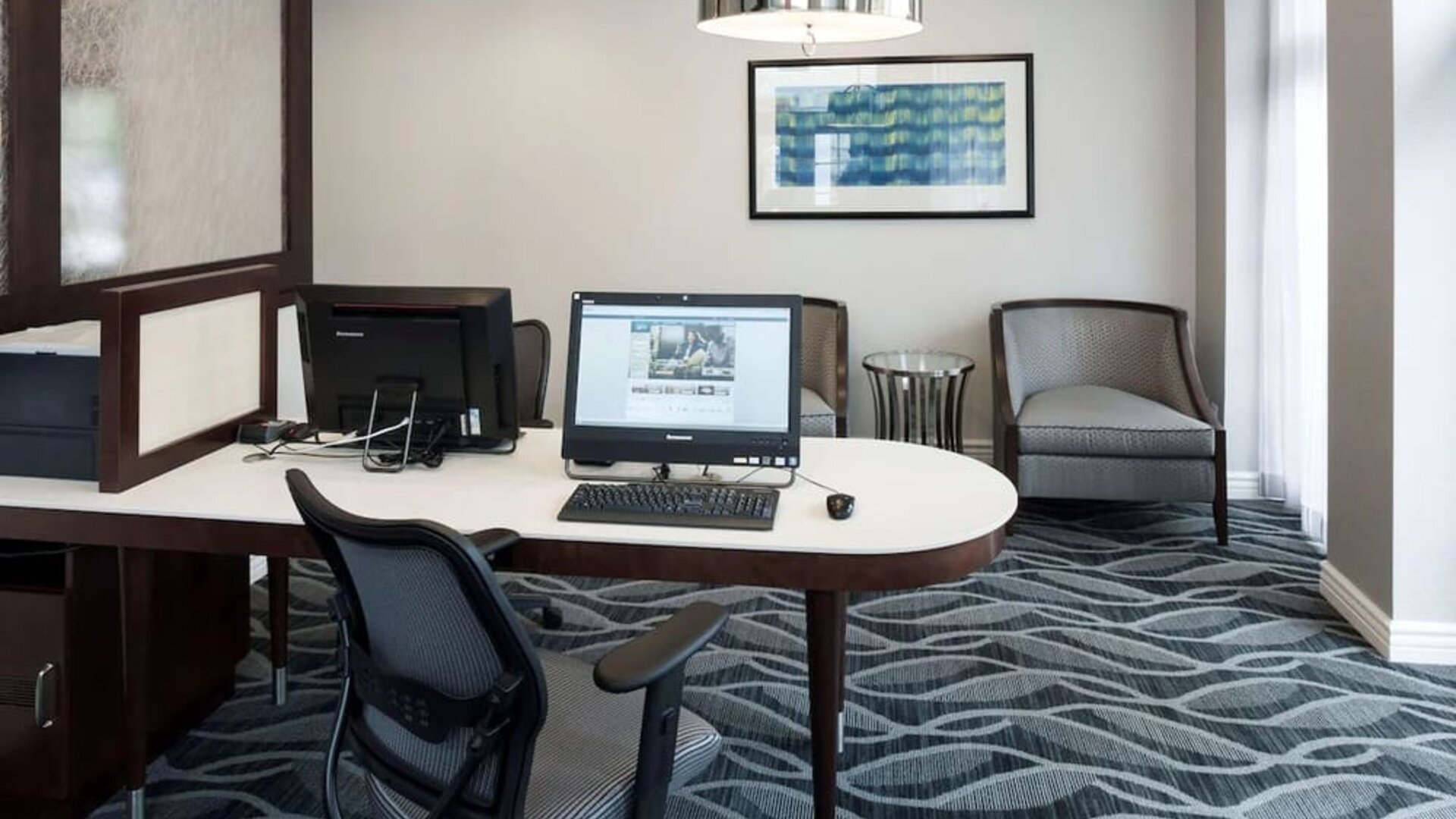Business center with computers, printer and ergonomic chairs atHomewood Suites By Hilton San Jose Airport-Silicon Valley.