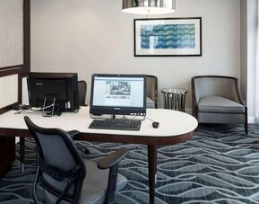 Business center with computers, printer and ergonomic chairs atHomewood Suites By Hilton San Jose Airport-Silicon Valley.