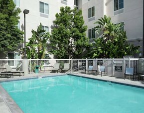 Outdoor pool with lounge chairs at Homewood Suites By Hilton Fresno Airport/Clovis.