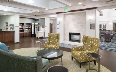 Lobby lounge with fireplace at Homewood Suites By Hilton Fresno Airport/Clovis.