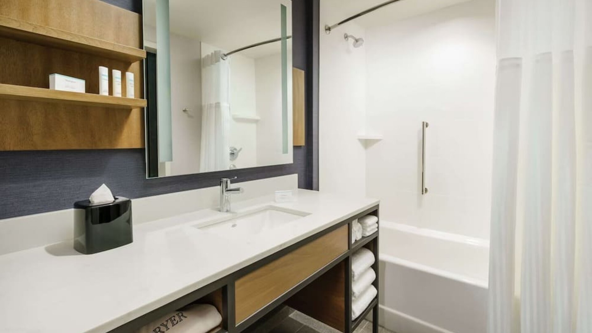 Private guest bathroom with combined shower and tub at Hilton Garden Inn Sunnyvale.