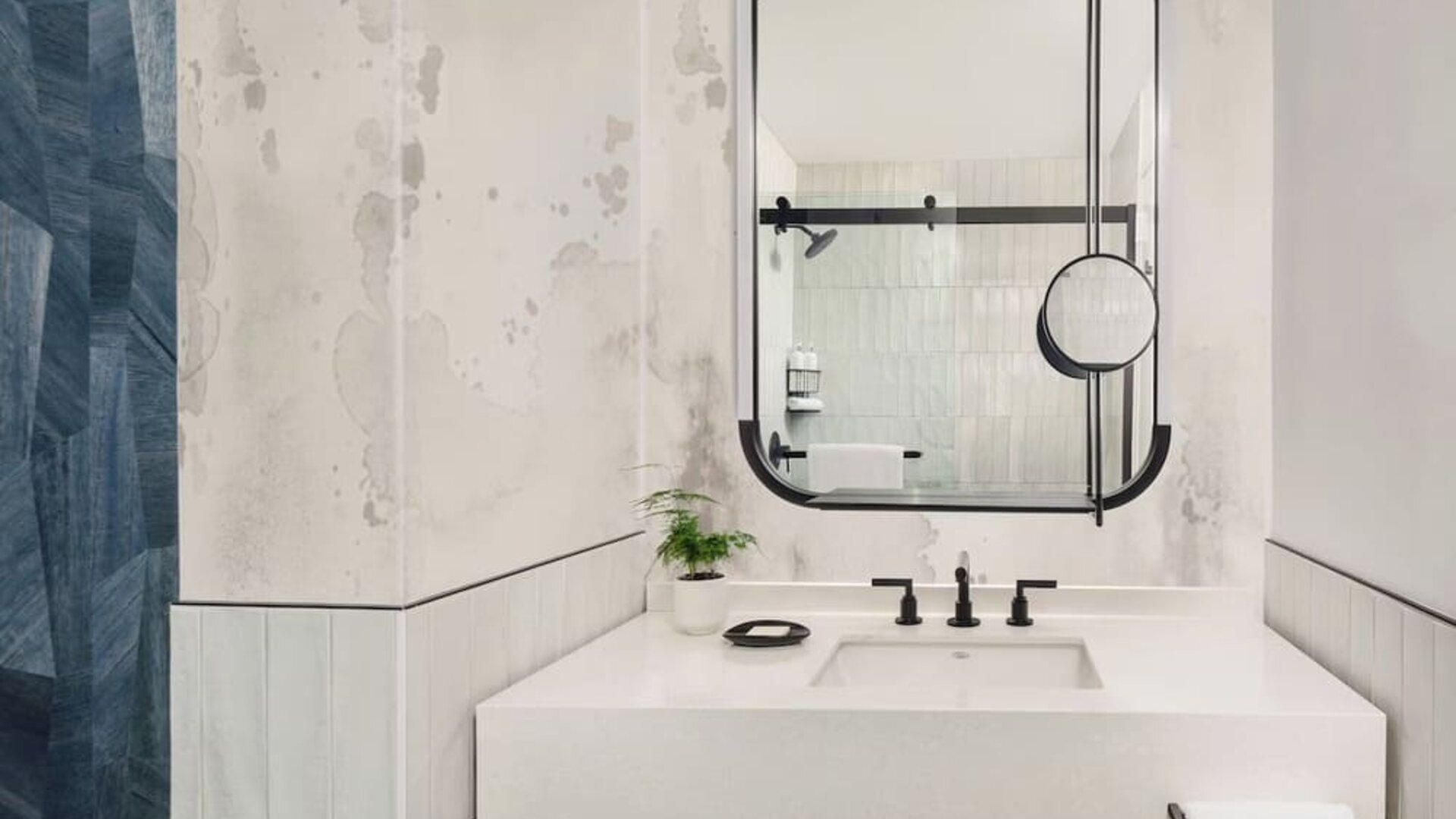 Private guest bathroom with shower and free toiletries at Kimpton Theta New York - Times Square.