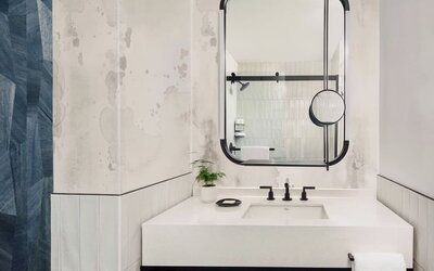 Private guest bathroom with shower and free toiletries at Kimpton Theta New York - Times Square.