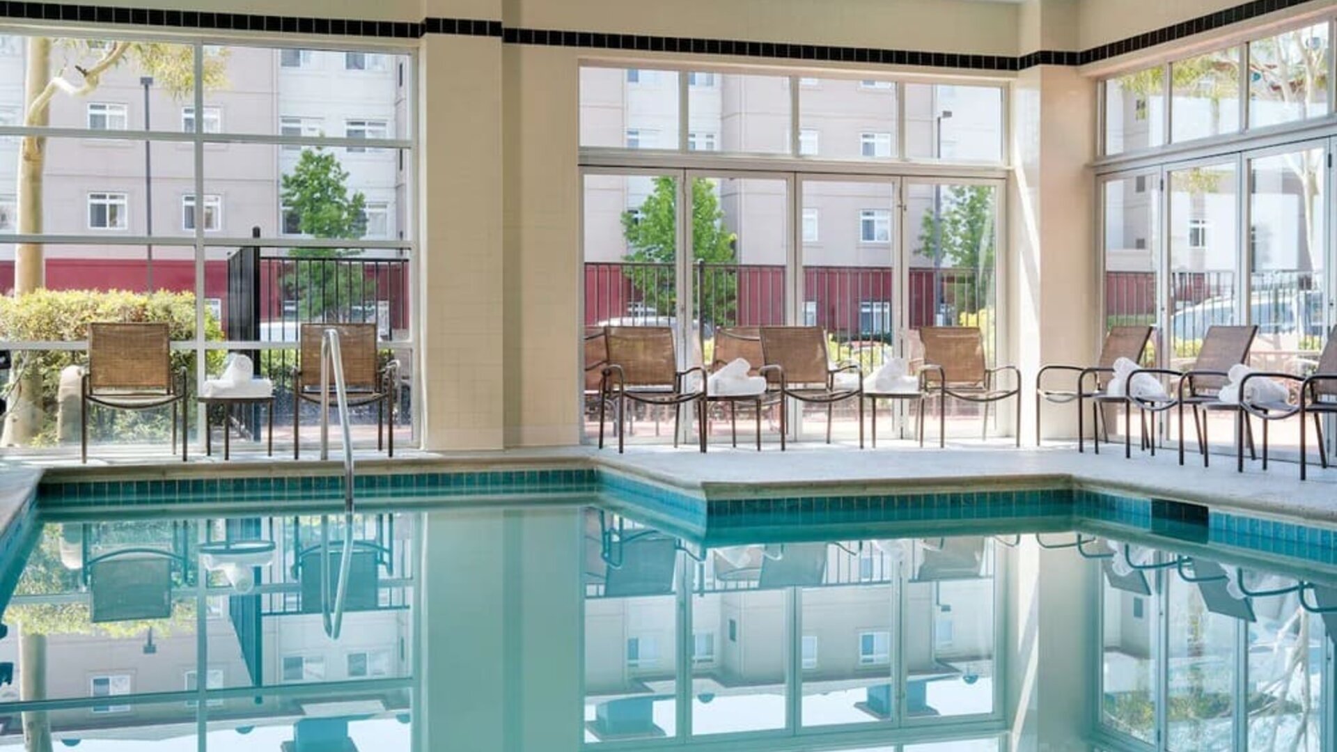 Relaxing indoor pool with lounge seating at DoubleTree By Hilton San Francisco Airport North Bayfront.