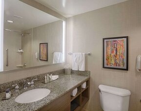 Private guest bathroom with shower and free toiletries at DoubleTree By Hilton San Francisco Airport North Bayfront.