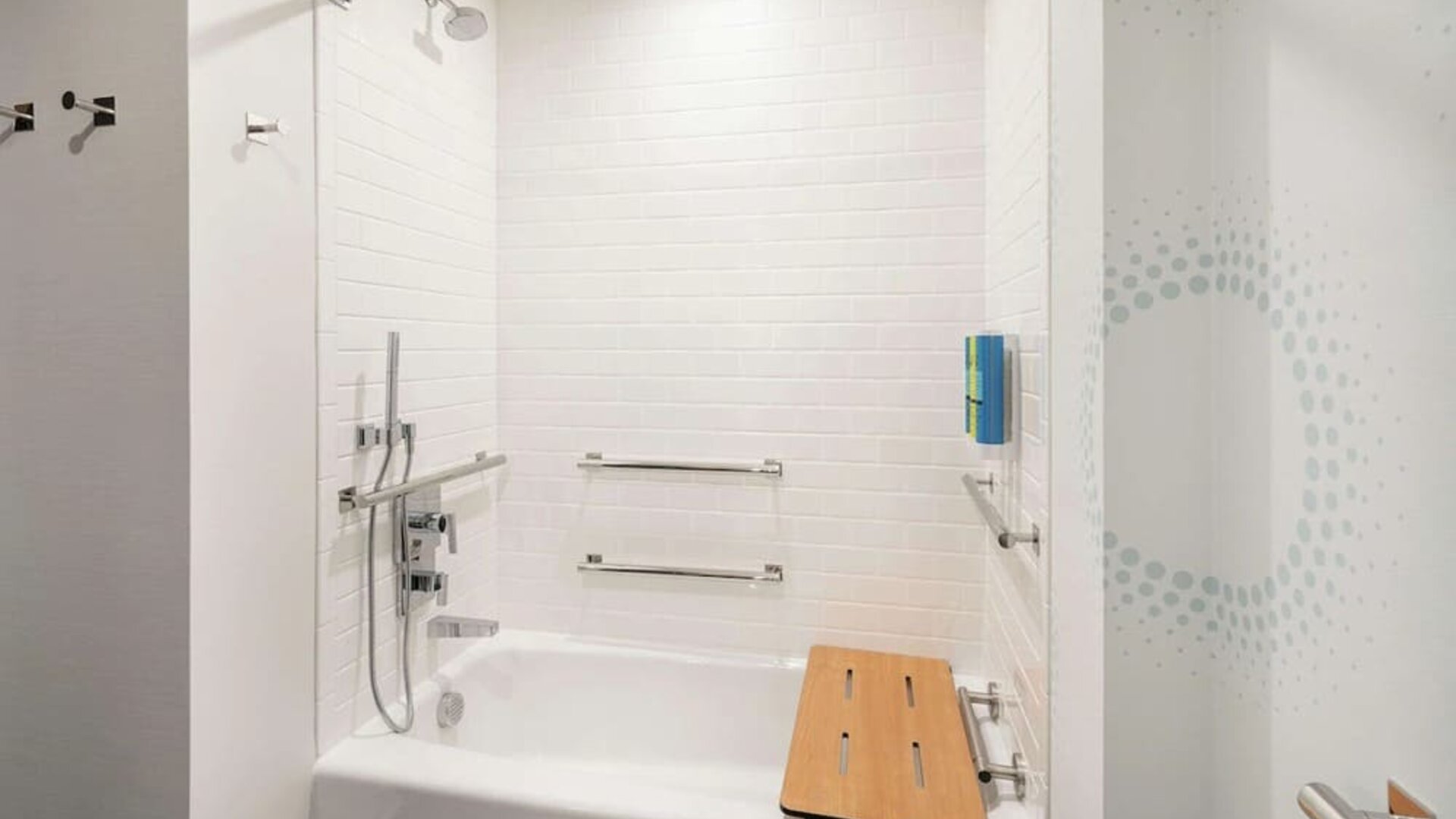Private guest bathroom with combined shower and tub at Tru By Hilton Denver Downtown Convention Center.