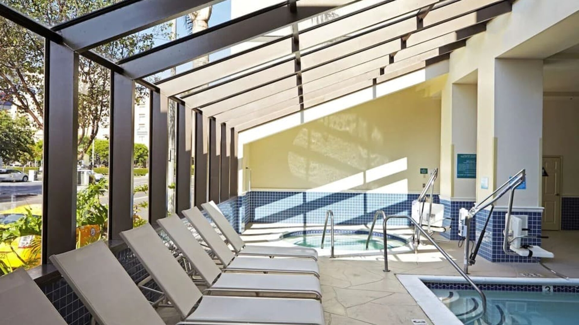 Indoor pool with jacuzzi and lounge area at Embassy Suites By Hilton Los Angeles-Intl Airport North.