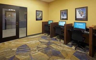 Business center with computers, printer and ergonomic chairs at Embassy Suites By Hilton Los Angeles-Intl Airport North.